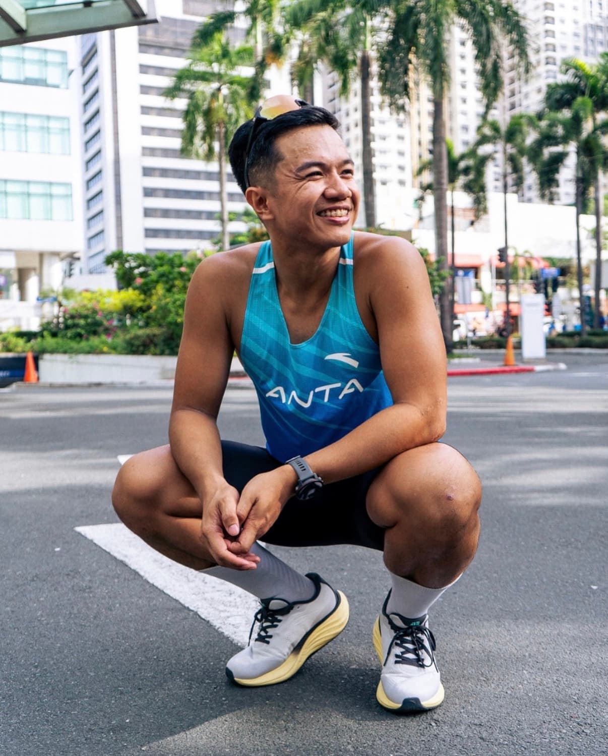 Coach Vans Catindoy smiling in an ANTA running singlet